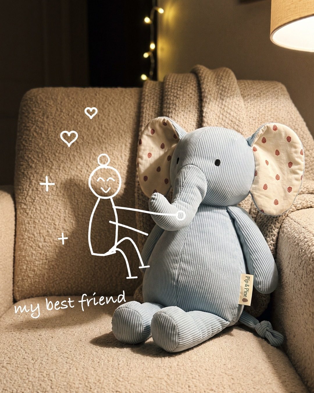 A blue corduroy plush elephant on an armchair, with a white line doodle of a child hugging it and the words my best friend